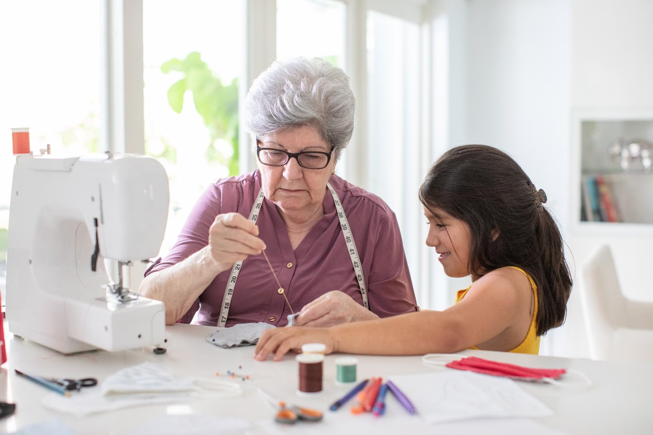 Learning how to sew with grandma at home